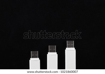 three white flash drives on a black background