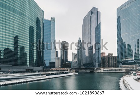 Skyscrapers and river in winter with grey sky