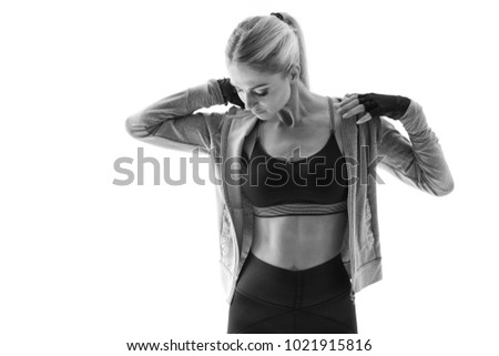 Black and white close-up shot of fit young female fitness model taking a break after workout Fitness woman in sportswear bra taking a break Attractive woman athlete bodybuilder posing