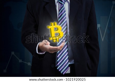 Closeup of anonymous businessman holding a virtual bitcoin symbol on his hand