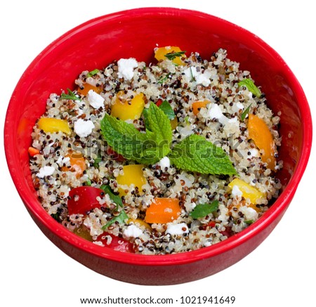 Closeup on red bowl with tri-color vegan quinoa salad isolated on white - quinoa is a pseudograin that has all nine essential amino-acids 