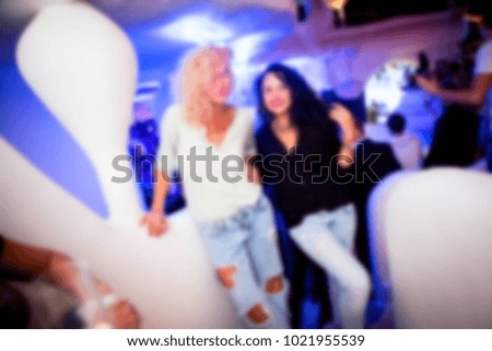 Blurred for background night club. Women smiling and posing on cam during concert in night club party. Girl have fun at club. girl at night club party