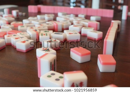 pink mahjong on table.