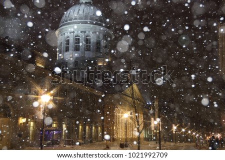 Old Montreal street view with historical buildings. Old Port of Montreal by night. View of Marche Bonsecours in old port in Montreal. Montreal Downtown Panorama at winter night. Snowfall