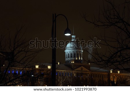 Old Montreal street view with historical buildings. Old Port of Montreal by snowfall. View of Marche Bonsecours in old port in Montreal. Montreal Downtown Panorama at winter night. 