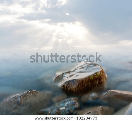stone in sea water in early morning