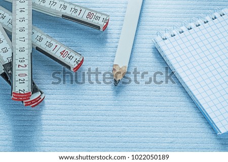 Notebook pencil tape measure construction concept.