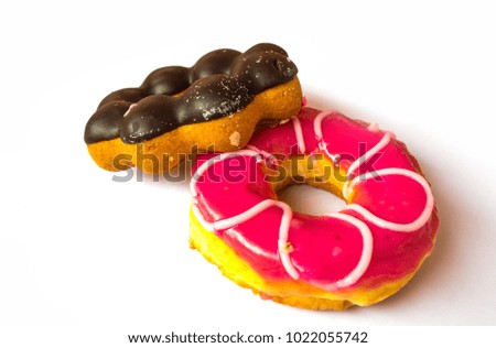 Two sweet donuts with chocolate glaze and sprinkles on white