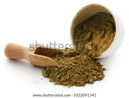 Henna hair dye powder in bowl with wooden scoppn over white background