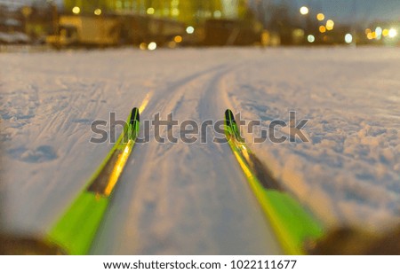 Photo of skis on background of burning lights