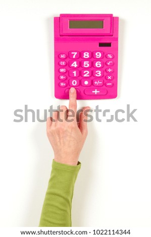 Hands in green jacket and red calculator on white background