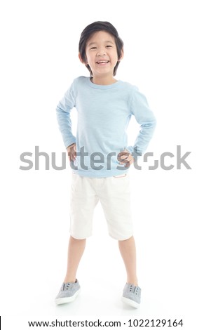 Cute Asian child  in blue t-shirt  standing on white background isolated