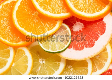 Top view of sliced different citrus fruits (orange, lemon, lime and grapefruit. )