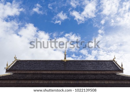 Ceramic tile on the temple roof with blue sky.