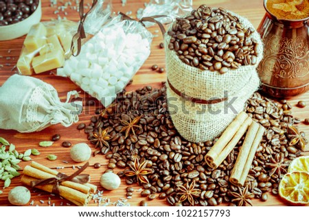 coffee beans and spices on an old wooden background, anise, cinnamon and nutmeg on the table