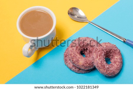 Coffee and doughnuts are on the simple background