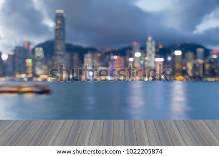 Opening wooden floor, City of Hong Kong downtown blurred bokeh light night view, abstract background