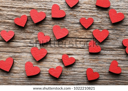 Red wooden hearts on grey table