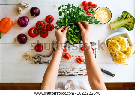 Top view womam hands. Food background. Food concept. Various fresh Ingredients for cooking. Picture of kitchen table with colorful vegetables . Sliced vegetables for making meal. Selective focus.