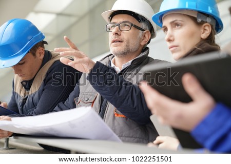 Instructor with young people in engineering training Royalty-Free Stock Photo #1022251501