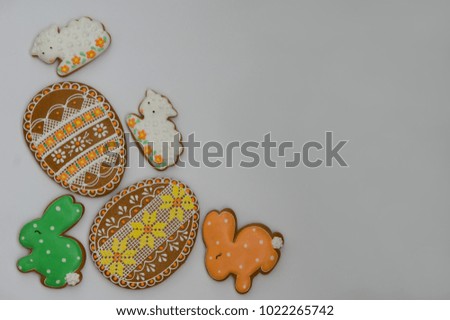 Beautiful Easter gingerbread cookies in the shape of the Easter eggs, bunnies and lambs decorated with sugar icing on the white background