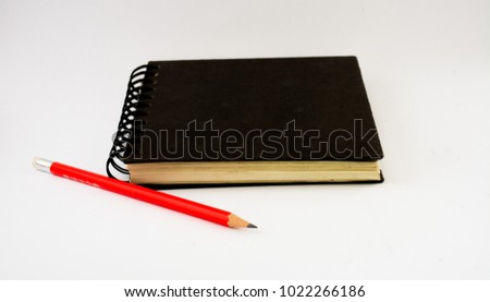 Perspective view of book and pencil on white background. Book and pen use for education.