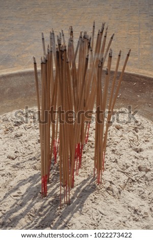 Incense sticks burning in a incense pot.