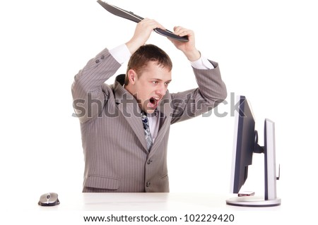 businessman sitting at a computer on a white background