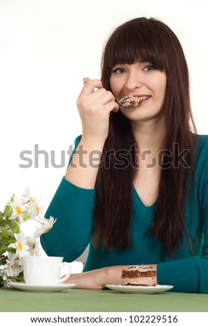 A beautiful caucasian girl sitting at a cafe and cake on a white background