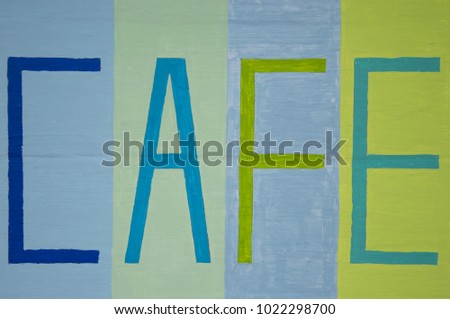 Painted wood panel background with café in capital letters