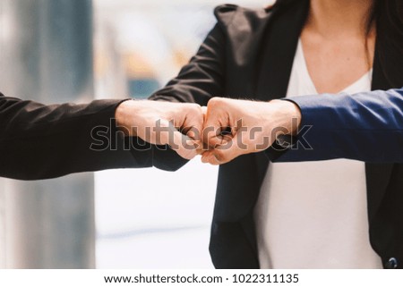 Teamwork of businessman and partner giving fist bump hand.Successful teamwork concept