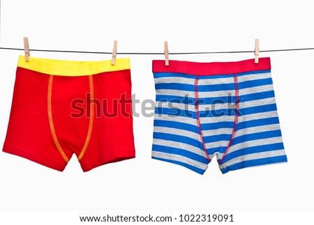  Male (boy) brief boxers hanging on the clothesline isolated on white background. Royalty-Free Stock Photo #1022319091