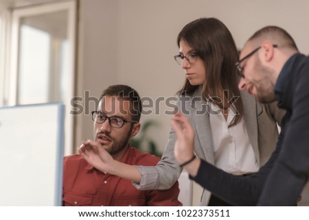 businessman by the desk discuss information with a younger colleague in a modern business lounge