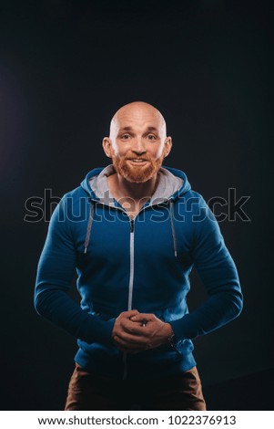 portrait of a young male bully who starts a fight over a black background