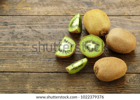 cut kiwi on a wooden background, the texture of the fruit is clearly visible. place for text
