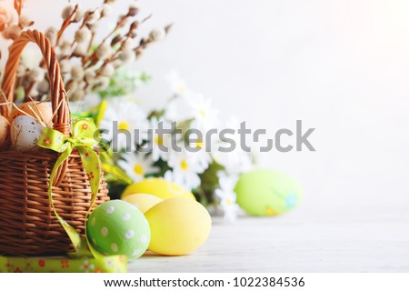 Happy Easter. Congratulatory easter background. Easter eggs and flowers. Royalty-Free Stock Photo #1022384536