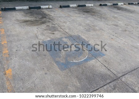 Handicapped parking in the gas station. Disable transportation infrastructure road markings.