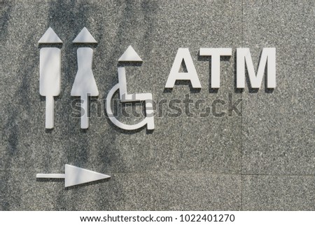 Symbol of a public toilet and atm banking.