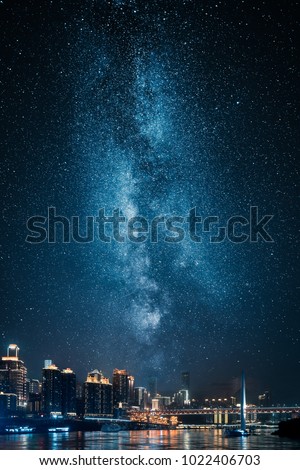 City skyline at night with milky way on sky
