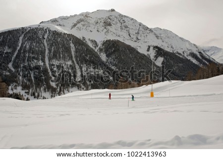 A ski teacher and kids learning skiing in the ski piste in the alps switzerland