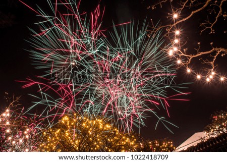 Celebratory Fireworks explode over colorful square and beautiful festival light, abstract and background for celebration. 