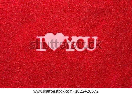 Finger write phrase I heart you on red sand top view, Valentines Day. 14 February. Wedding