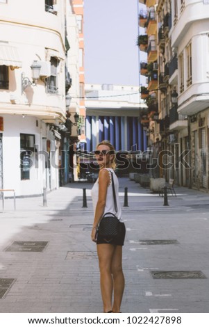Attractive blonde woman in European street