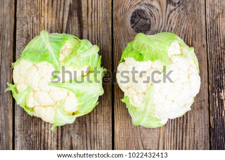 Fresh cauliflower on wooden table. Studio Photo