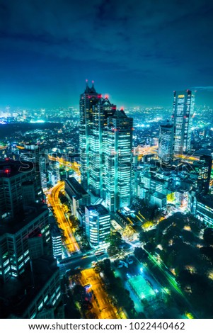 Asia Business concept for real estate and corporate construction - modern city skyline aerial night view of Shinjuku and Tokyo Metropolitan Expressway under twilight sky in Tokyo, Japan