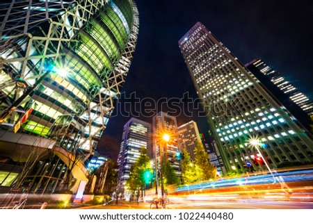 Asia Business concept for real estate and corporate construction - looking up night view in road intersection of shinjuku, the silhouettes of skyscrapers reflect twilight sky in Tokyo, Japan