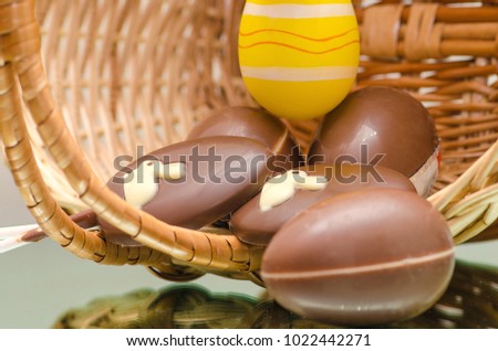 Chocolate Easter bunny eggs and sweets in Easter basket.