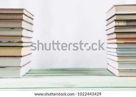 Pile of various books on bright wooden background. With copy space for your text