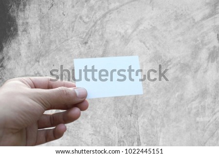White business card in hand