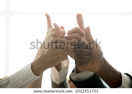 Multiracial team hands showing thumbs up finger gesture, motivated diverse corporate group showing like celebrating racial equality, successful teamwork, recommending business solution, close up view Royalty-Free Stock Photo #1022451751